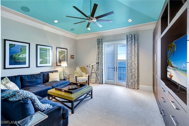 living room featuring ceiling fan, light colored carpet, and ornamental molding