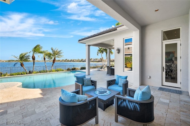 view of pool featuring a patio, a water view, and an outdoor living space with a fire pit