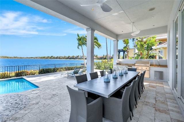 view of patio / terrace with a grill, area for grilling, a water view, and a fenced in pool