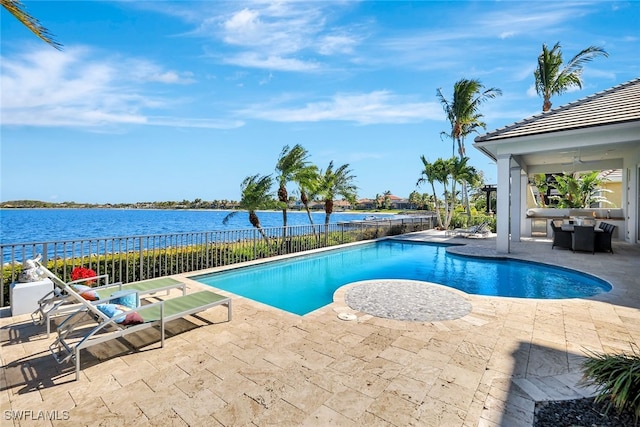 view of swimming pool with a patio, a water view, and ceiling fan