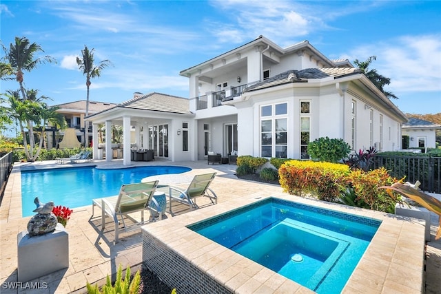 view of swimming pool with an in ground hot tub and a patio area