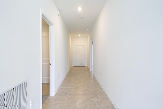 corridor with light tile patterned flooring