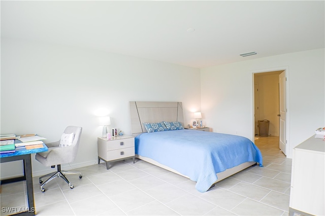 bedroom with light tile patterned floors