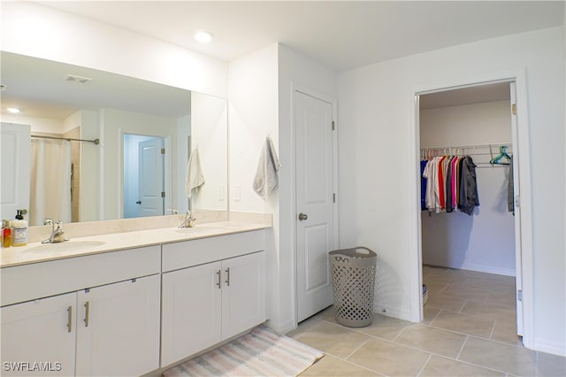 bathroom featuring tile patterned flooring and vanity