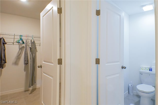 bathroom featuring tile patterned flooring and toilet