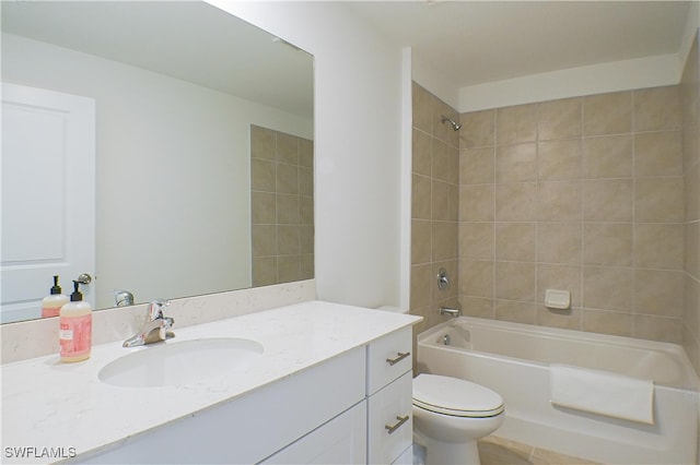 full bathroom with toilet, vanity, and tiled shower / bath