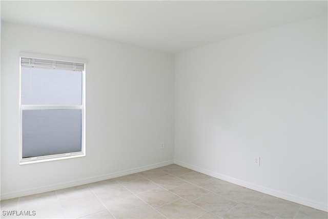 unfurnished room with light tile patterned flooring