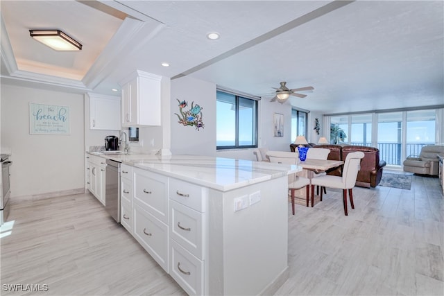 kitchen with white cabinets, ceiling fan, light wood-type flooring, appliances with stainless steel finishes, and kitchen peninsula