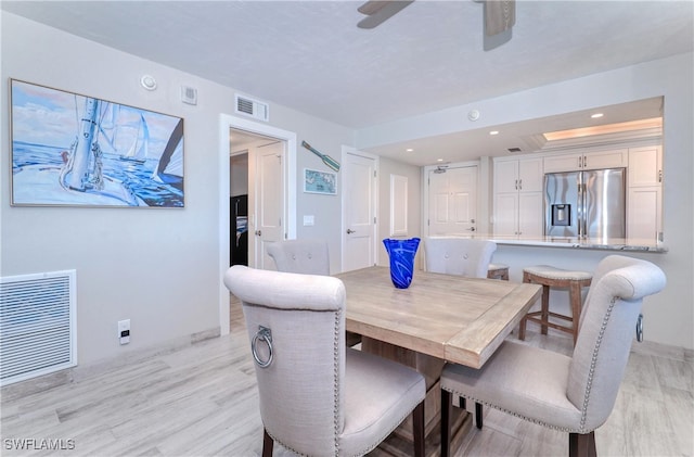 dining area featuring light hardwood / wood-style flooring and ceiling fan