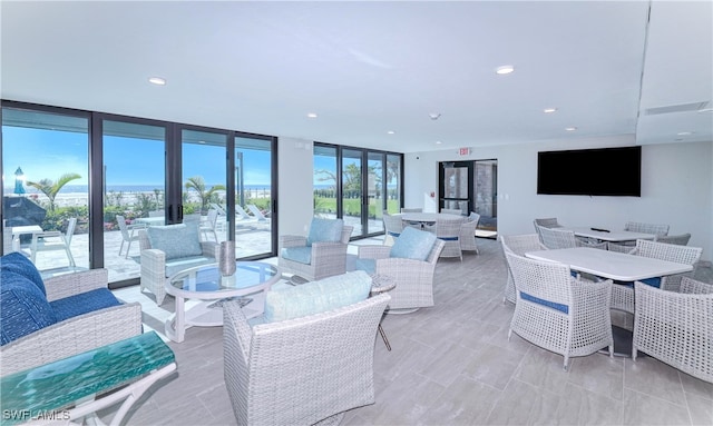 living room featuring a wall of windows and french doors