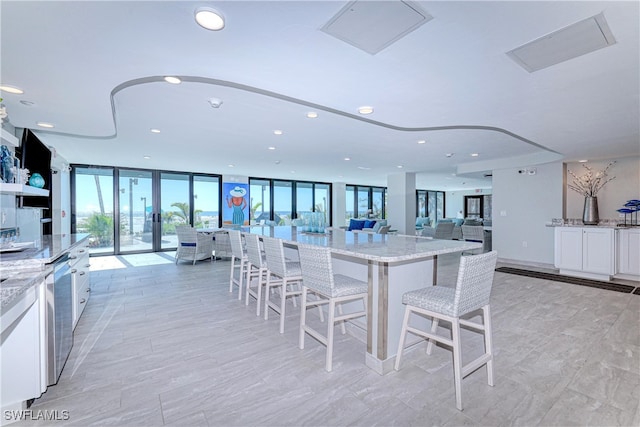 dining area with a wall of windows and french doors