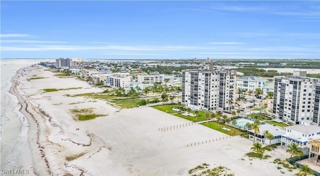 bird's eye view featuring a view of the beach and a water view