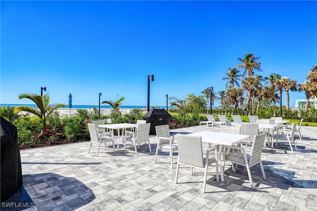 view of patio / terrace featuring a grill and a water view