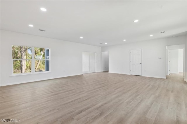 empty room with light hardwood / wood-style floors