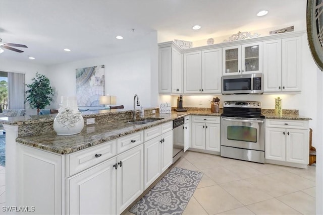 kitchen with white cabinets, sink, kitchen peninsula, and stainless steel appliances