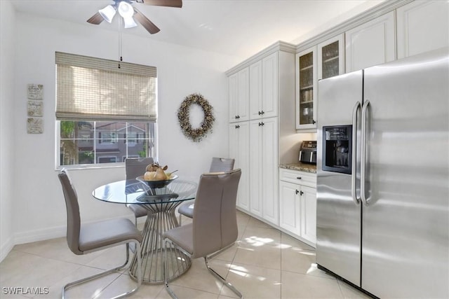 tiled dining room featuring ceiling fan