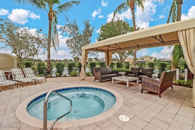 view of pool featuring an in ground hot tub, an outdoor living space, and a patio area