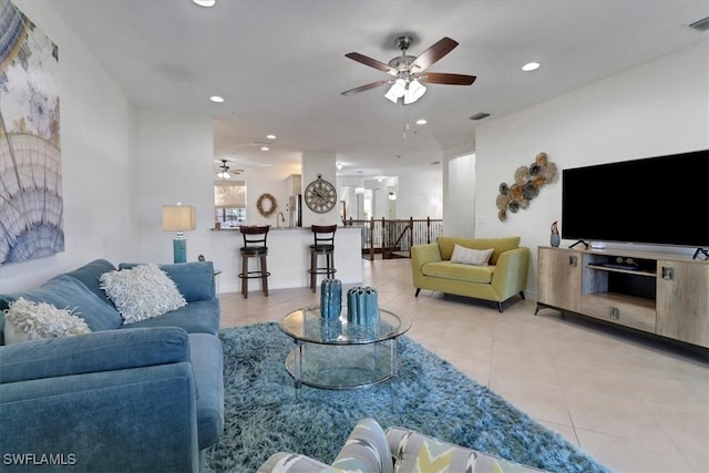 living room featuring light tile patterned floors and ceiling fan