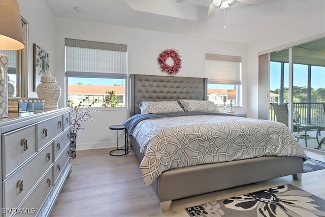 bedroom with access to outside, ceiling fan, and light hardwood / wood-style flooring