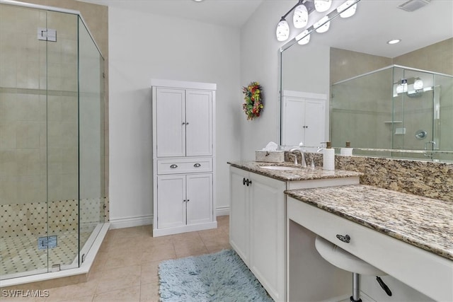 bathroom with tile patterned floors, vanity, and an enclosed shower