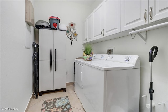 laundry area featuring light tile patterned floors, cabinets, and washer hookup