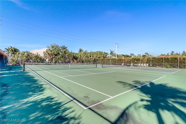 view of tennis court featuring fence