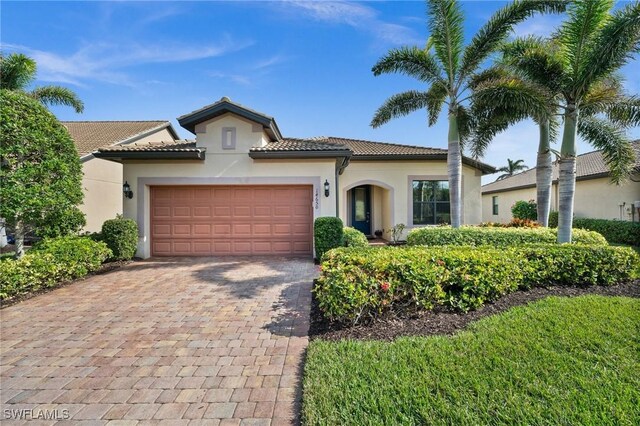 mediterranean / spanish house with a garage