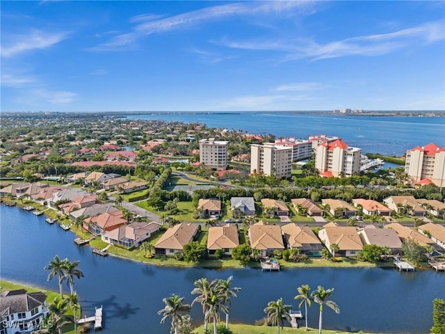 drone / aerial view featuring a residential view and a water view