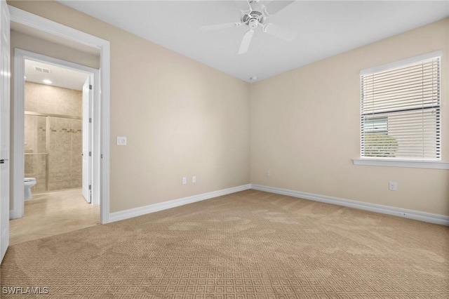 empty room featuring carpet floors, visible vents, ceiling fan, and baseboards