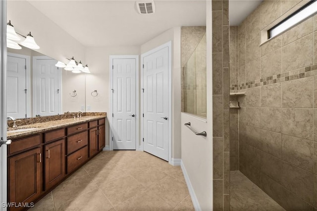 bathroom with a walk in shower, double vanity, a sink, and visible vents