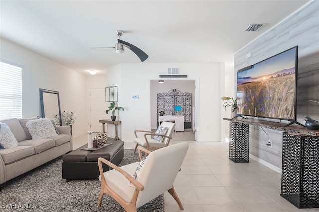 tiled living room with ceiling fan