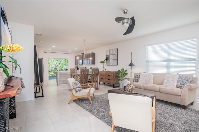 tiled living room with ceiling fan