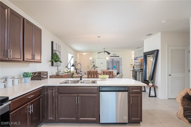 kitchen featuring dishwasher, kitchen peninsula, sink, and decorative light fixtures