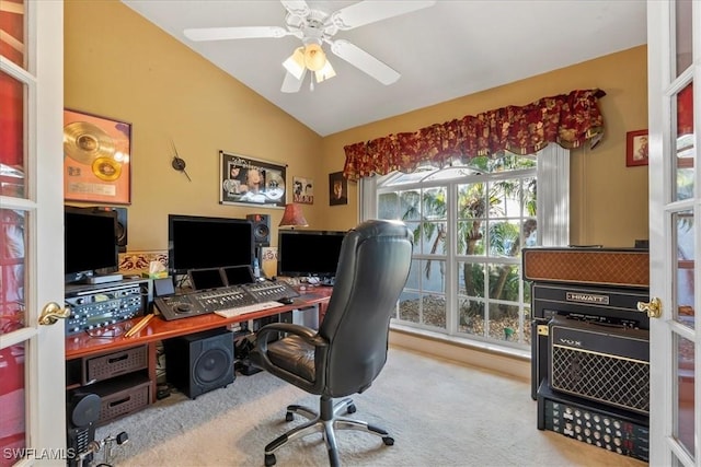 home office featuring light carpet, ceiling fan, and vaulted ceiling