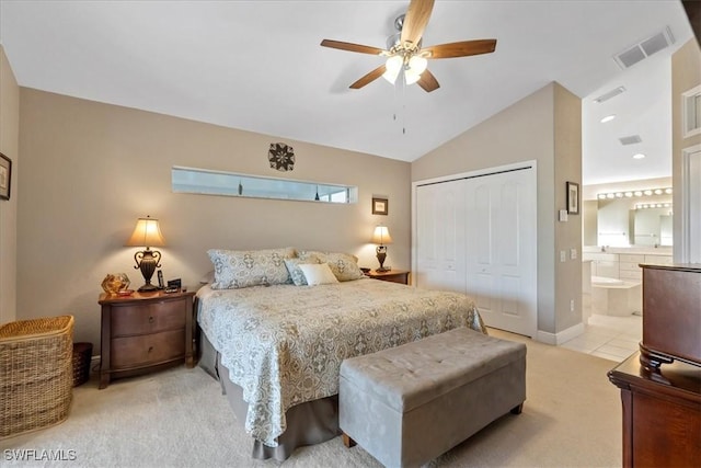 carpeted bedroom featuring ensuite bath, ceiling fan, a closet, and lofted ceiling