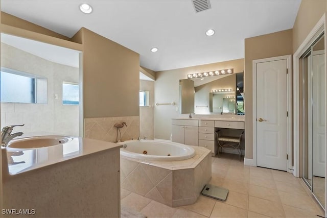 bathroom with vanity, tiled bath, and tile patterned floors