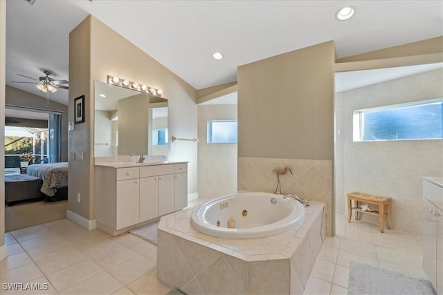 bathroom featuring tile patterned flooring, vaulted ceiling, a wealth of natural light, and ceiling fan