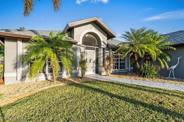 entrance to property featuring a lawn