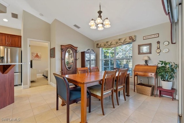 dining area featuring light tile patterned floors, lofted ceiling, and a notable chandelier