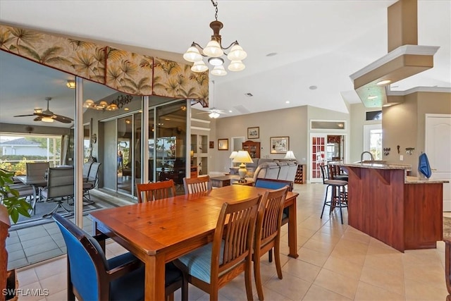 dining space featuring vaulted ceiling, french doors, light tile patterned floors, and ceiling fan with notable chandelier