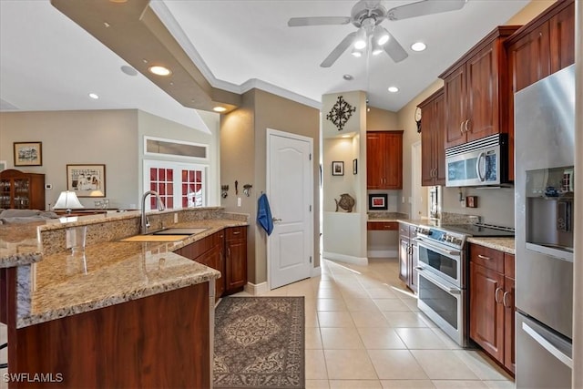 kitchen with appliances with stainless steel finishes, light stone counters, crown molding, sink, and light tile patterned floors