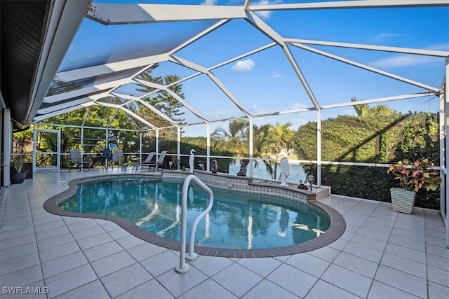 view of pool featuring glass enclosure and a patio area