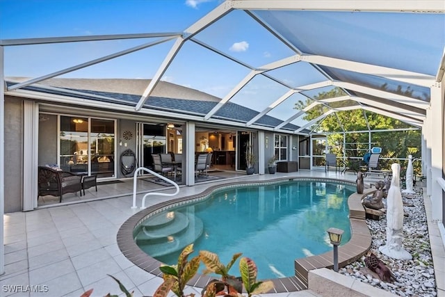 view of swimming pool featuring a lanai and a patio