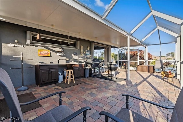 view of patio featuring a grill, a lanai, and exterior bar