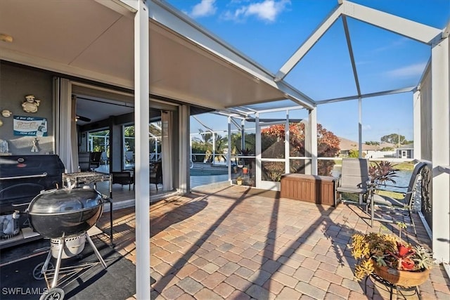 view of patio / terrace featuring glass enclosure, a grill, and a pool