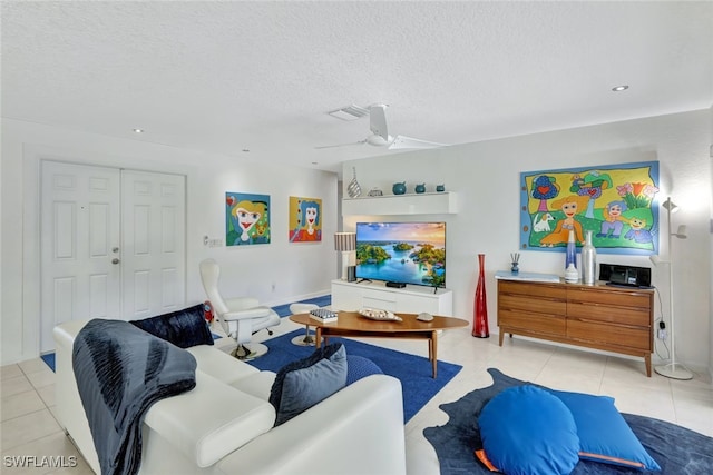 tiled living room featuring a textured ceiling and ceiling fan