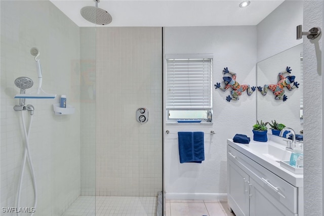 bathroom featuring tile patterned floors, a shower with door, and vanity