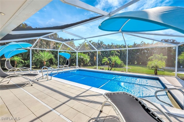 view of pool featuring glass enclosure and a patio area