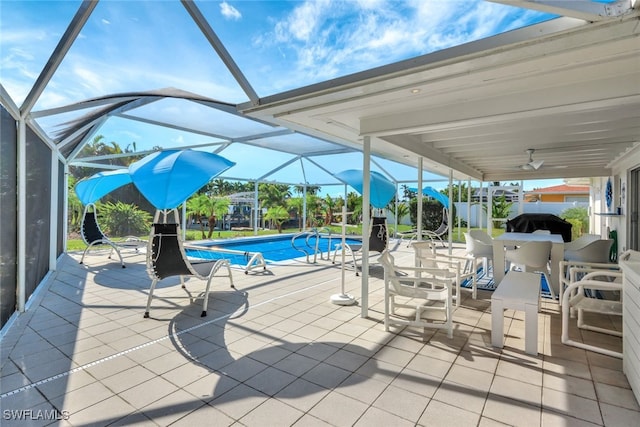 view of pool featuring ceiling fan, a patio area, and glass enclosure