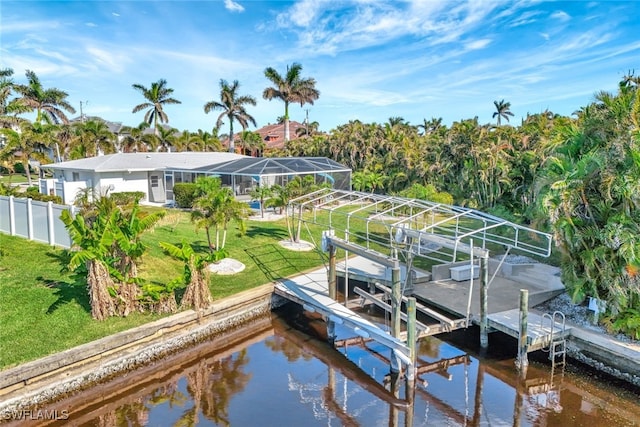 view of dock featuring a lawn and a water view